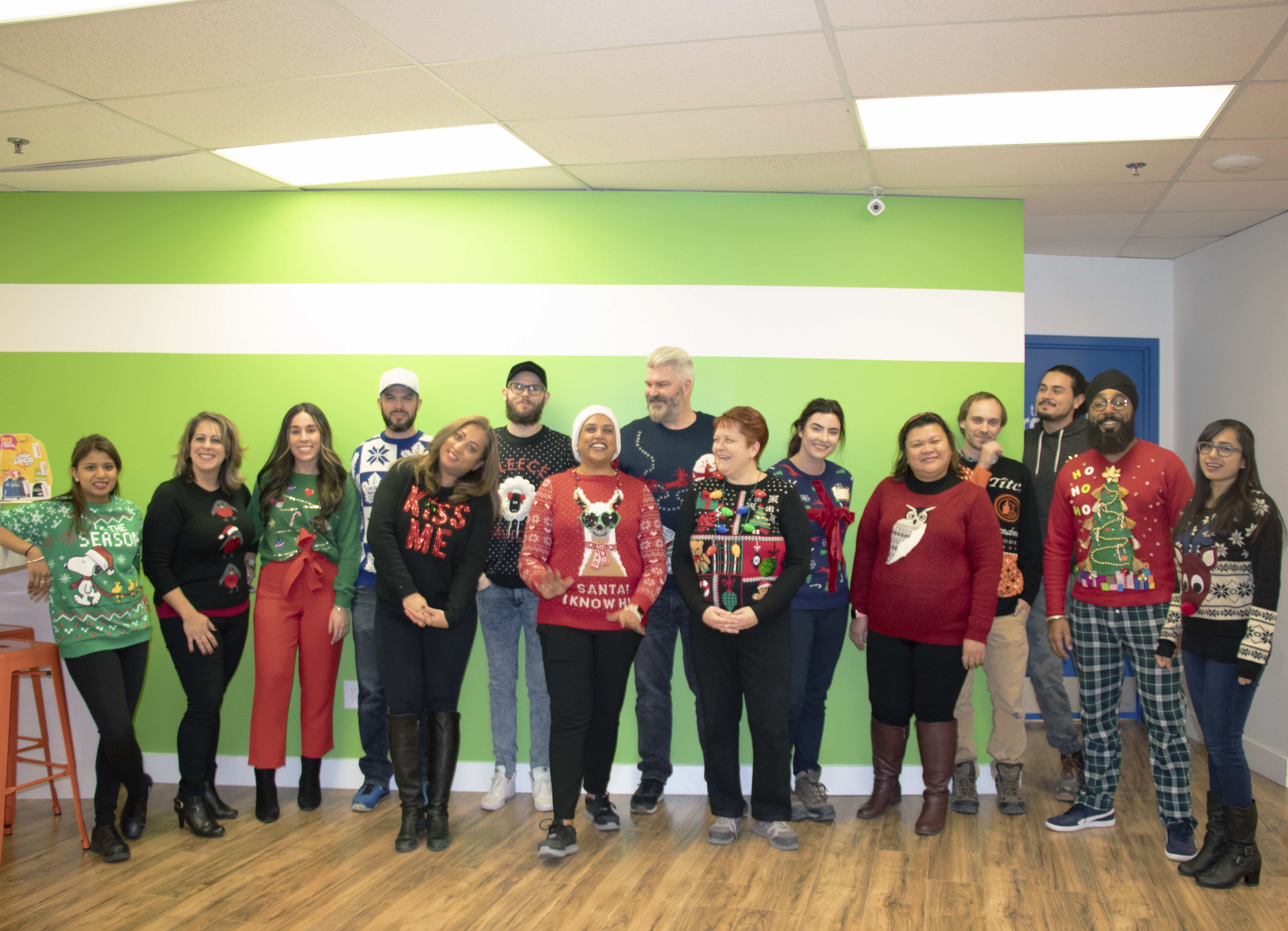 Entripy employees wearing christmas sweaters for ugly sweater contest.